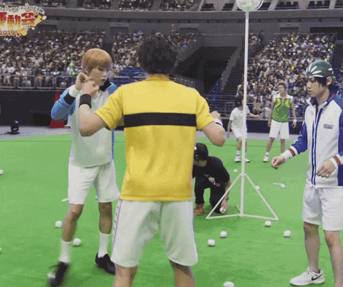 a man in a yellow shirt is standing in front of a crowd