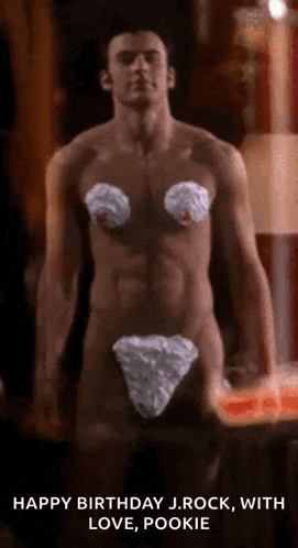 a shirtless man is standing in front of a candle while wearing a white underwear .