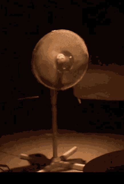 a fan is lit up in the dark with a light shining on it