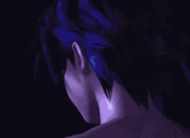 a man without a shirt is standing in front of a blue light
