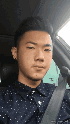 a man wearing a polka dot shirt and a black tie