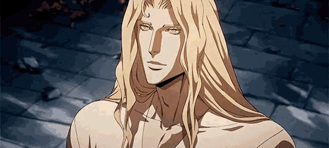 a man with long blonde hair is standing on a brick sidewalk and looking at the camera .