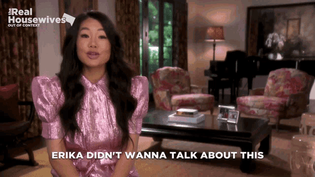 a woman in a pink dress says erika did n't wanna talk about this while sitting in a living room