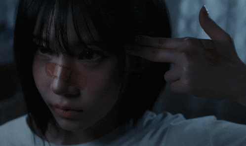 a woman with a bandage on her nose is pointing her finger at herself