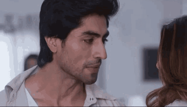 a man and a woman are looking at each other with their eyes closed