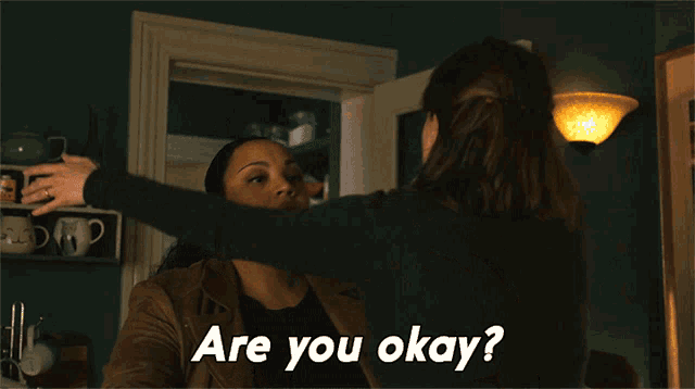 a woman hugging another woman with the words " are you okay " below her