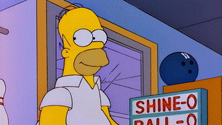 homer simpson is standing in front of a shine-o ball sign