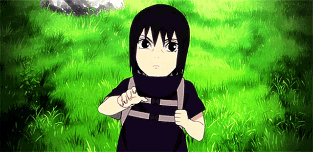 a little boy with a backpack stands in a field of grass