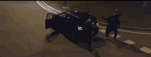 a car is sitting on the side of the road with its doors open