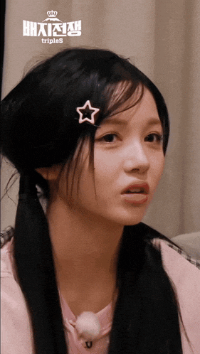 a girl with a star in her hair has triples written on the bottom