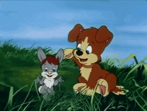 a dog and a rabbit are sitting in the grass together