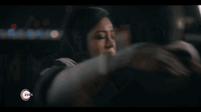 a man is hugging a woman with the words zeus download now on the bottom of the screen