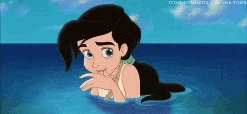 a little mermaid is laying in the ocean with her hand on her chin .