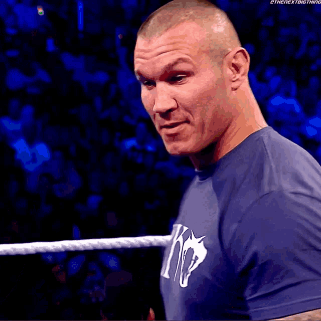 a man wearing a blue shirt that says #out on it