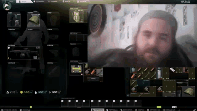a man with a beard is playing a video game with a foreign language on the screen
