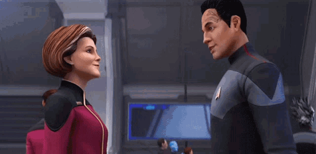 a man and a woman standing next to each other with the man wearing a star trek uniform