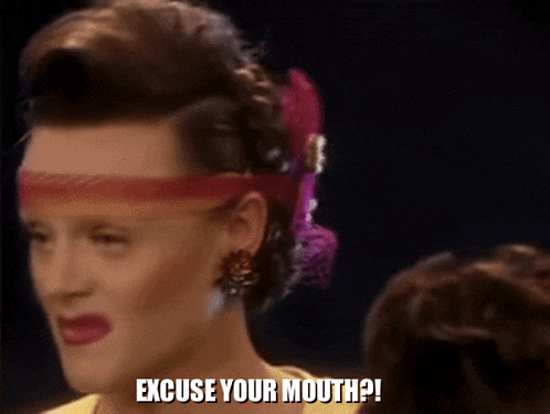 a woman wearing a headband and earrings is saying excuse your mouth