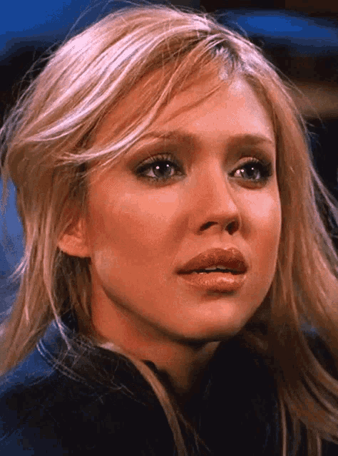 a close up of a woman 's face with blonde hair