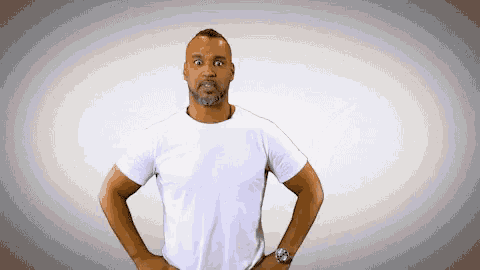 a man in a white shirt has his hands on his hips and looks surprised