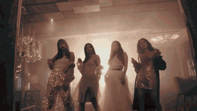 a group of women standing in a room with smoke coming out of the ceiling