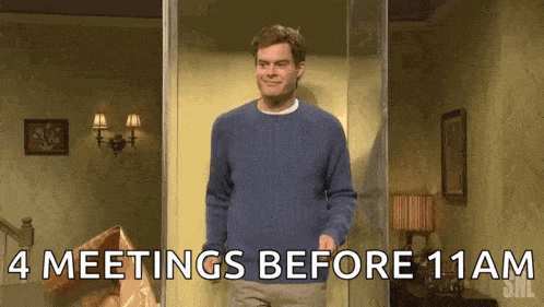 a man in a blue sweater is standing in a room with the words " 4 meetings before 11am " written on the bottom