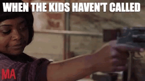 a woman is holding a gun in her hand in a garage .