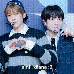 two young men are making a heart shape with their hands and the caption says emi i diana : 3