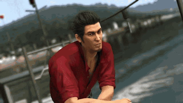 a man in a red shirt sits on a boat