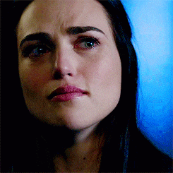 a close up of a woman 's face with a tear running down her cheek