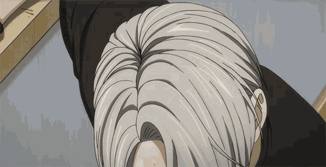 a close up of a person 's hair with a black shirt