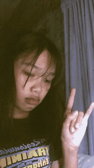 a girl wearing a shirt that says ' jimiah ' on the front