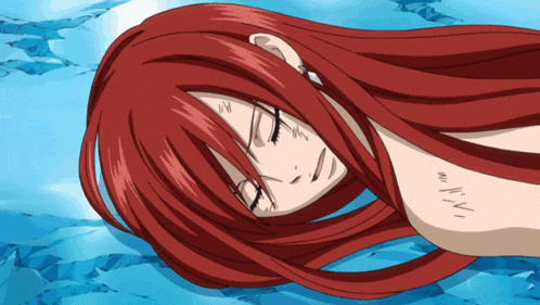 a woman with long red hair has a tattoo on her chest that says ' n.v.i. '