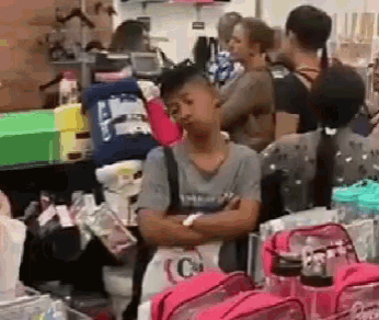 a man standing in a store with his arms crossed .