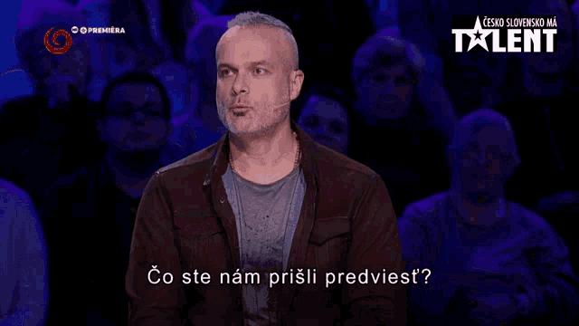 a man stands in front of a crowd with the words co ste nam prišli predviest