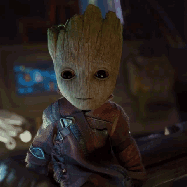 a close up of a baby groot holding a sword in his mouth