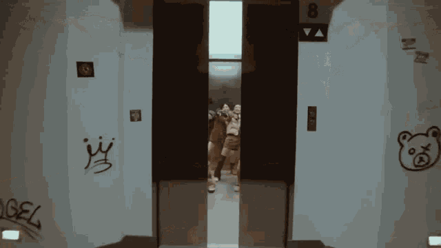 an elevator with graffiti on the walls including one that says angel