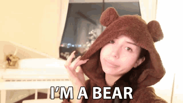 a woman wearing a teddy bear hooded sweatshirt says i 'm a bear