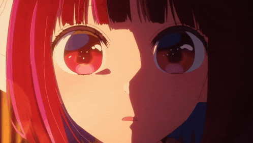 a close up of a girl 's face with red hair and blue eyes