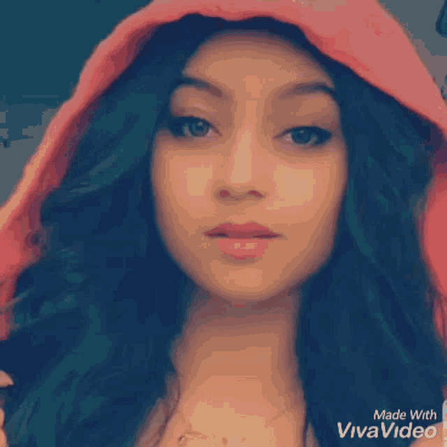 a woman wearing a red hooded jacket made with viva video
