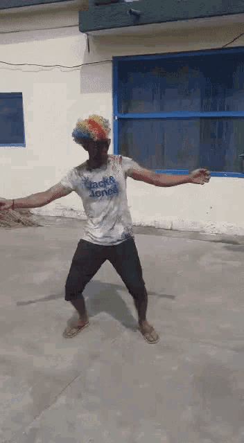 a man wearing a clown wig and a jack & jones shirt is dancing