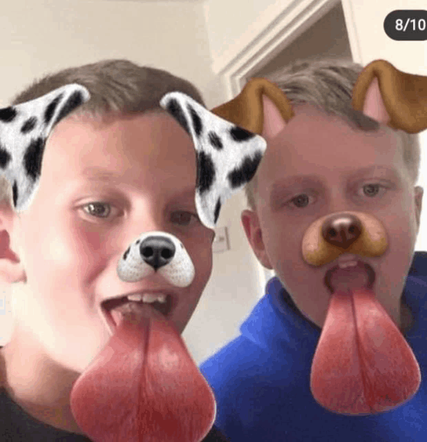 two boys wearing dalmatian dog ears and tongues sticking out