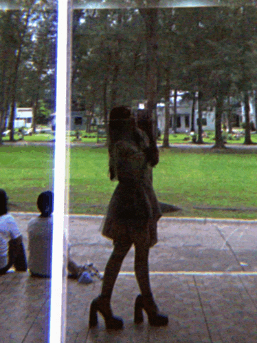 a reflection of a woman taking a picture of herself