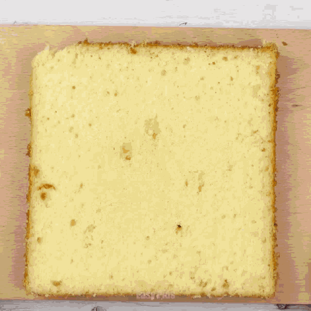 a person with a gold ring on their finger is cutting a piece of bread
