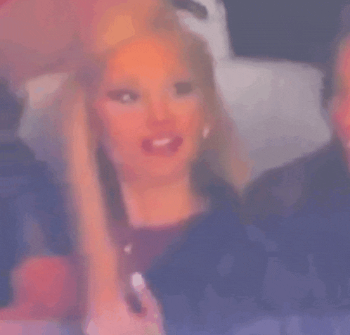 a close up of a woman 's face with a blurry background .