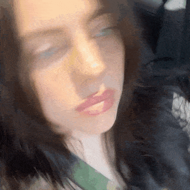 a close up of a woman 's face in a car