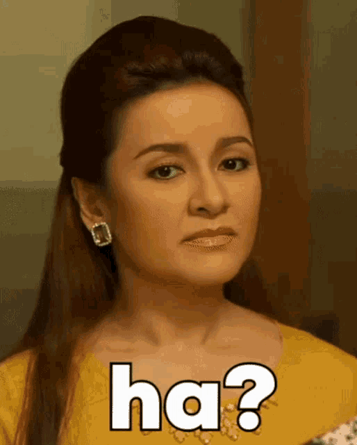 a woman in a yellow dress is making a funny face with the words ha written on her face