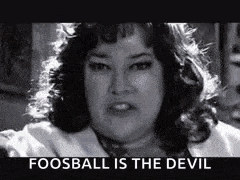 a black and white photo of a woman with the words `` fooball is the devil '' above her .