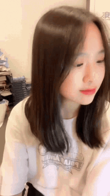 a girl wearing a white shirt that says " body a major " on it