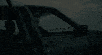 a man is getting out of a car with his door open