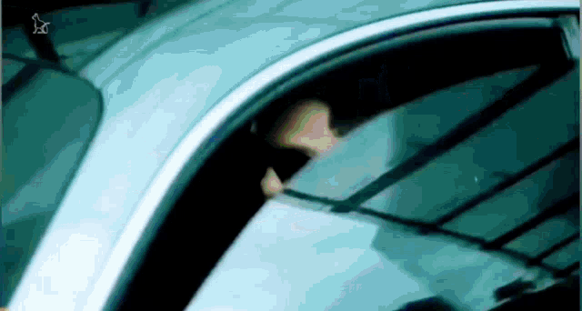 a person is looking out of a car window .